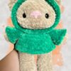Tan crochet bear plushie in a green hoodie - front view