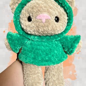Tan crochet bear plushie in a green hoodie - front view