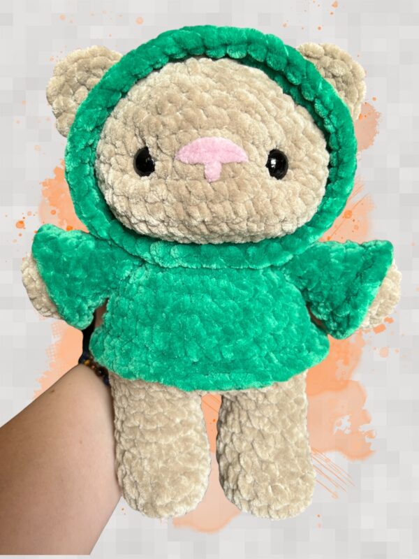 Tan crochet bear plushie in a green hoodie - front view