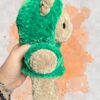 Tan crochet bear plushie in a green hoodie - right view