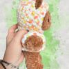 Rust brown crochet bear plushie in a yellow and orange speckled hoodie - right view