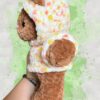 Rust brown crochet bear plushie in a yellow and orange speckled hoodie - left view