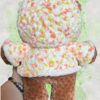 Rust brown crochet bear plushie in a yellow and orange speckled hoodie - back view