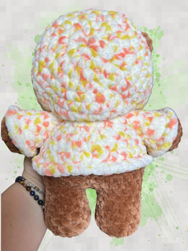 Rust brown crochet bear plushie in a yellow and orange speckled hoodie - back view