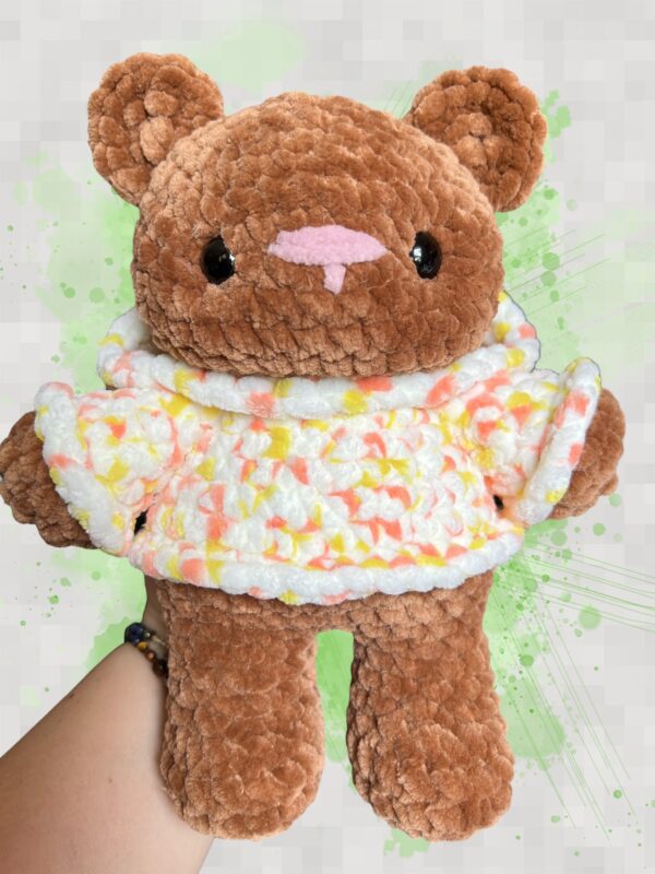 Rust brown crochet bear plushie in a yellow and orange speckled hoodie - front view no hood