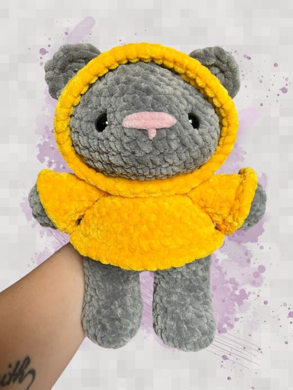 dark grey bear in a yellow hoodie