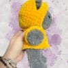 dark grey bear in a yellow hoodie