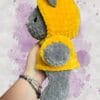 dark grey bear in a yellow hoodie