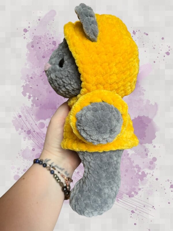 dark grey bear in a yellow hoodie