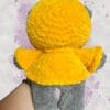 dark grey bear in a yellow hoodie