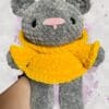 dark grey bear in a yellow hoodie