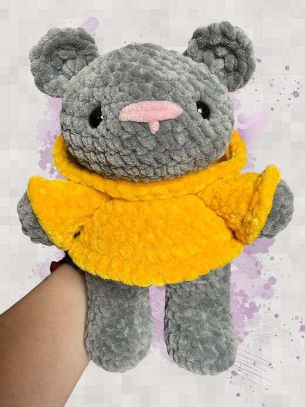 dark grey bear in a yellow hoodie