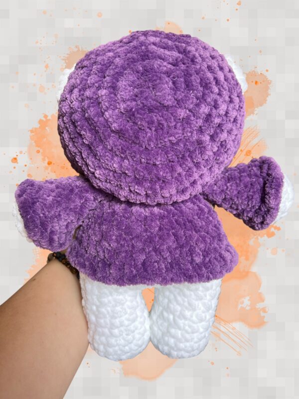 White crochet bear plushie in a purple hoodie - back view
