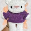 White crochet bear plushie in a purple hoodie - front view no hoodie