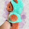 Rust crochet bear plushie in an aquamarine hoodie - left view