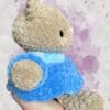 beige bear in a blue dress