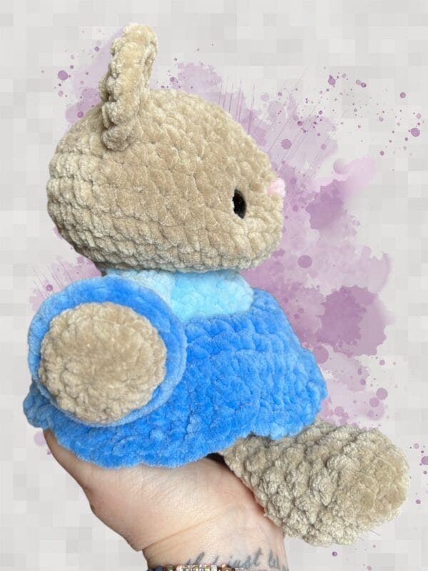 beige bear in a blue dress