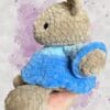 beige bear in a blue dress