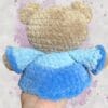 beige bear in a blue dress