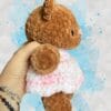 caramel brown bear in a pink & white dress