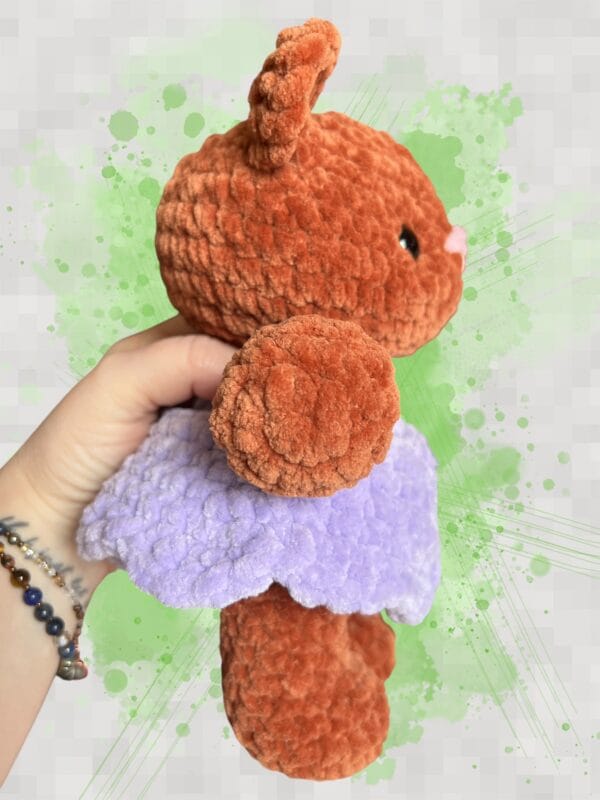 plush rust brown bear in a lavender dress