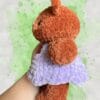 plush rust brown bear in a lavender dress
