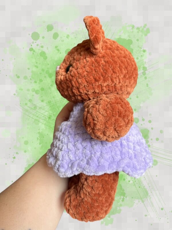 plush rust brown bear in a lavender dress