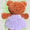 plush rust brown bear in a lavender dress