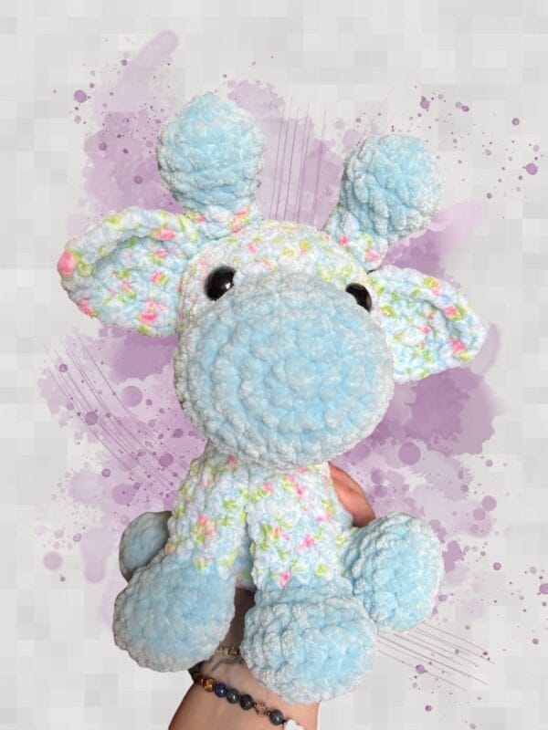 Giraffe sitting light blue